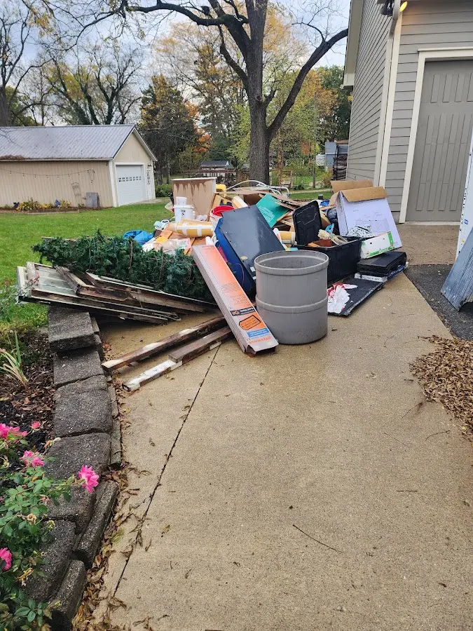 Dumpster being loaded with debris for Estate Cleanout Dumpster Rental in Lacey